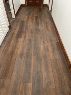 Hardwood hallway floor before cleaning