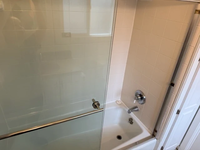 Detailed shower and tub with clean glass door